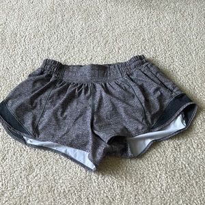 Lululemon Hotty Hot shorts low-rise 2.5 inch. Color is Heathered Black.